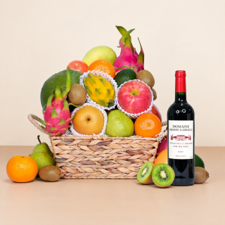 Traditional fresh fruit basket with red wine